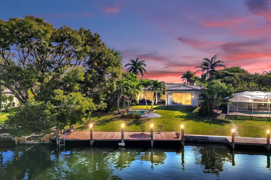 Situated on an expansive 19k sq ft waterfront lot, this private paradise offers 45 feet of dockage and breathtaking, unobstructed views of the Middle River.