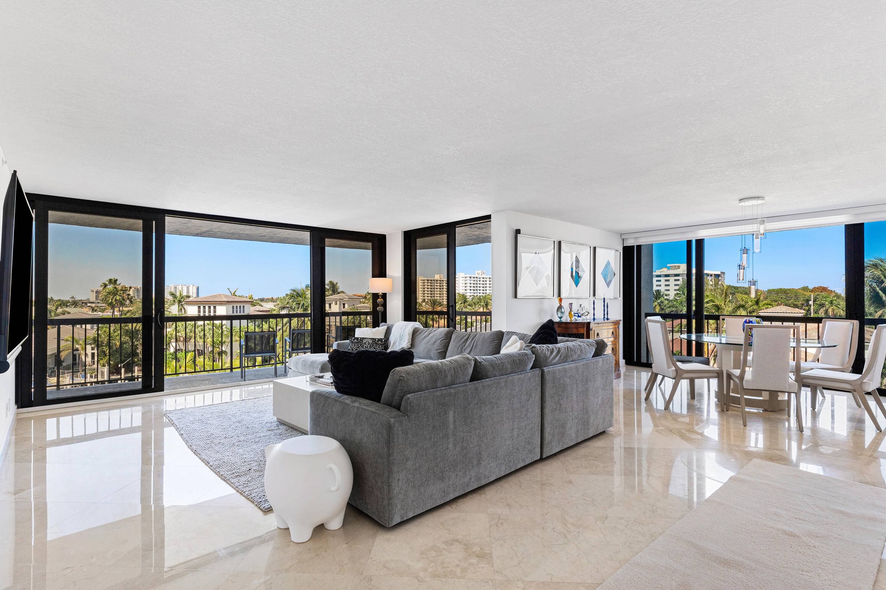 Indulge in resort style living with this luxury corner unit featuring panoramic water views and a private dock, located in the prestigious Boca Highland Beach Club Marina.