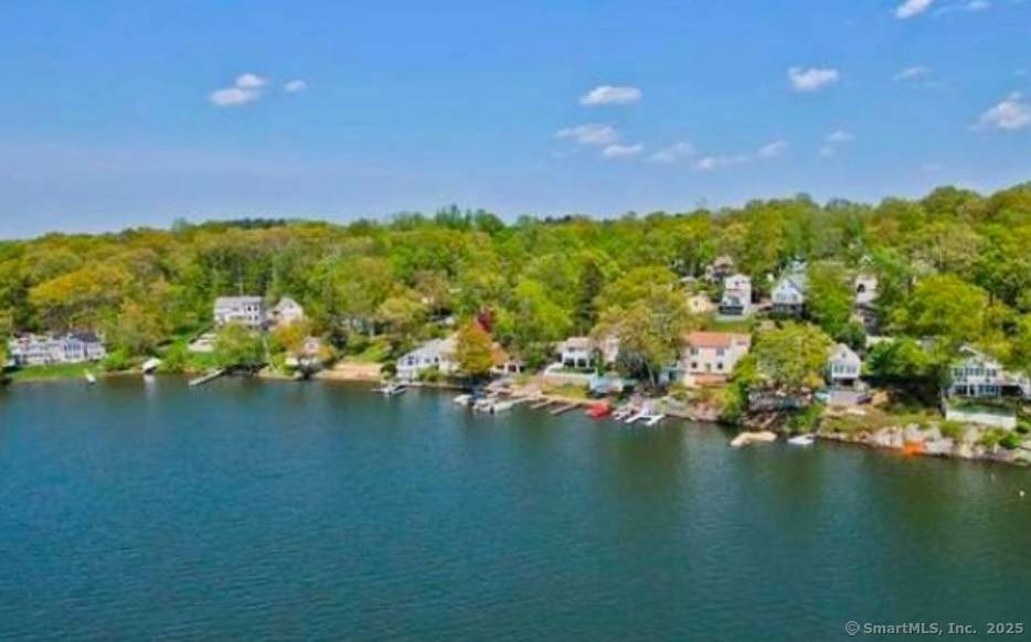 Welcome to this beautiful year round remodeled lake home offering breathtaking views overlooking the shimmering waters of Lake Pocotopaug.