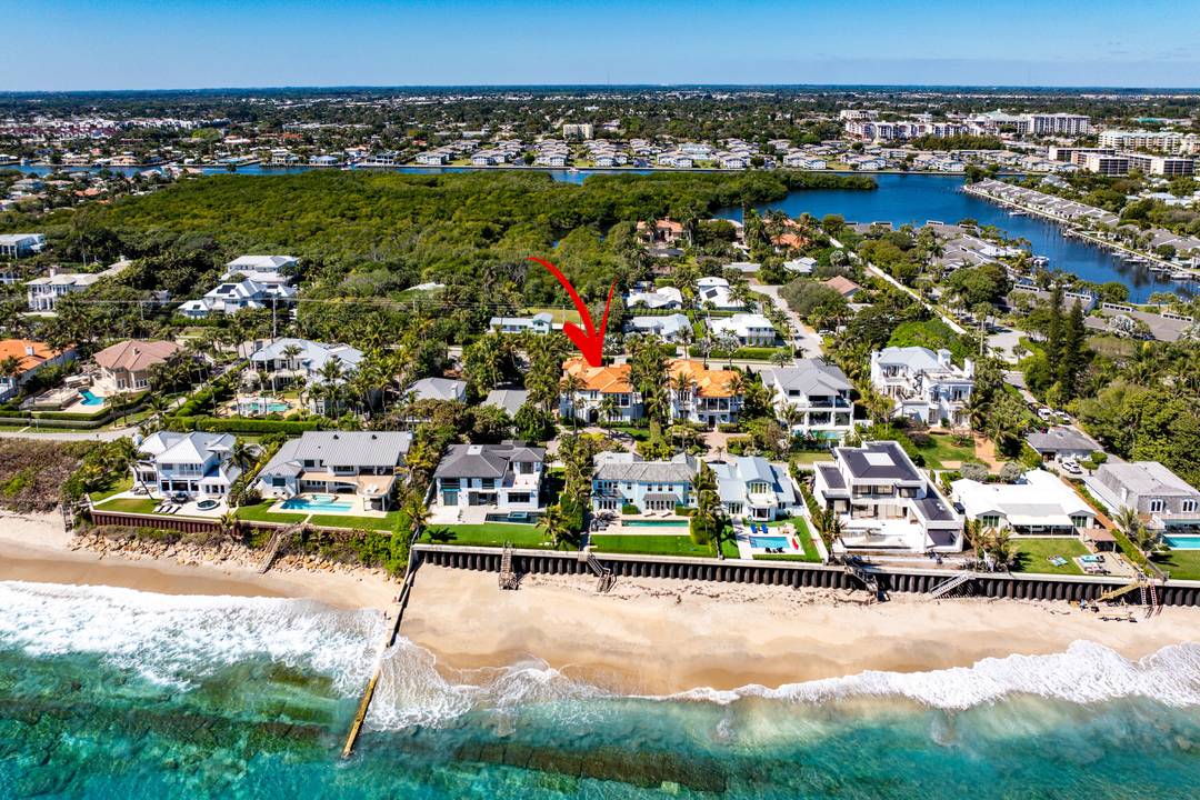 This Ocean Ridge estate embodies refined coastal living, offering easy access to a secluded beach just steps from the sand.