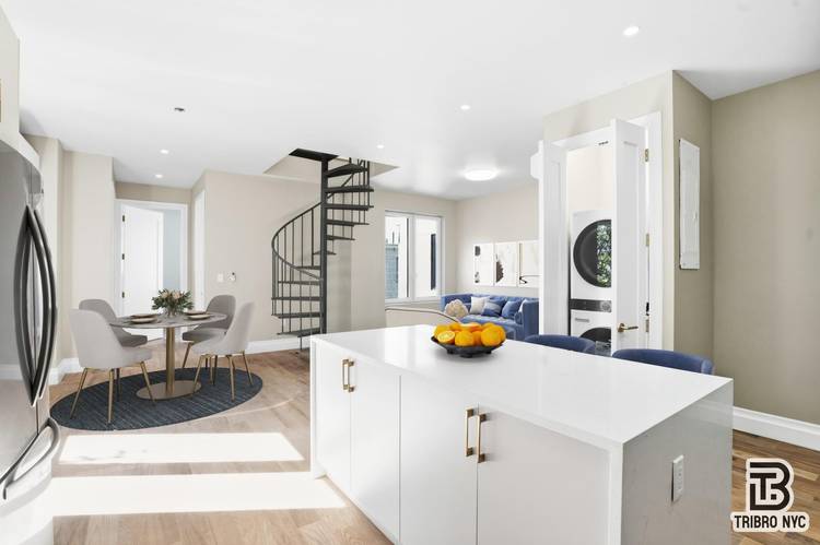 Expansive 5BR 2BA residence offering sleek modern design, high ceilings, and an in unit washer dryer.