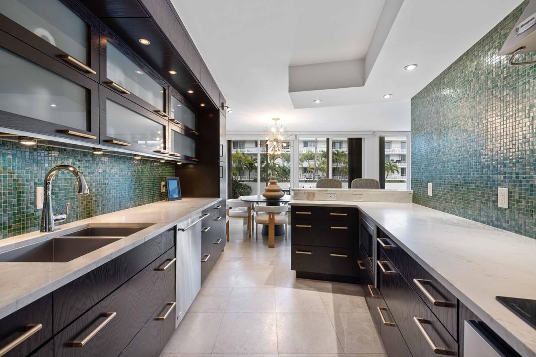 2BR 2. 5 BA turn key in town condo with deeded beach access and a rare expansive wraparound terrace overlooking Sunrise Ave.