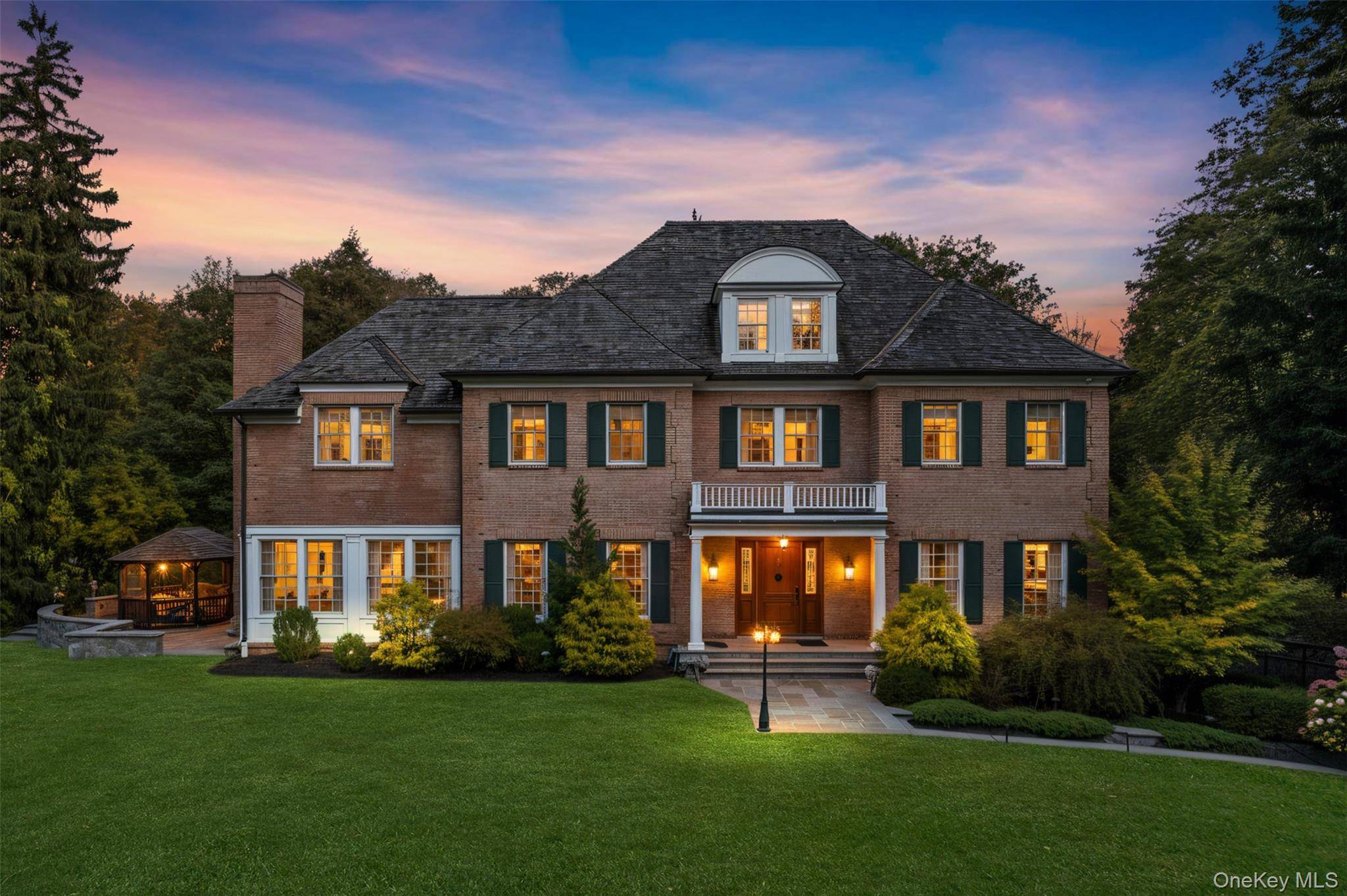 Privately gated and masterfully crafted, this exceptional custom brick estate is a showcase of timeless elegance and grand scale living, nestled on over two acres in the heart of Chappaqua.