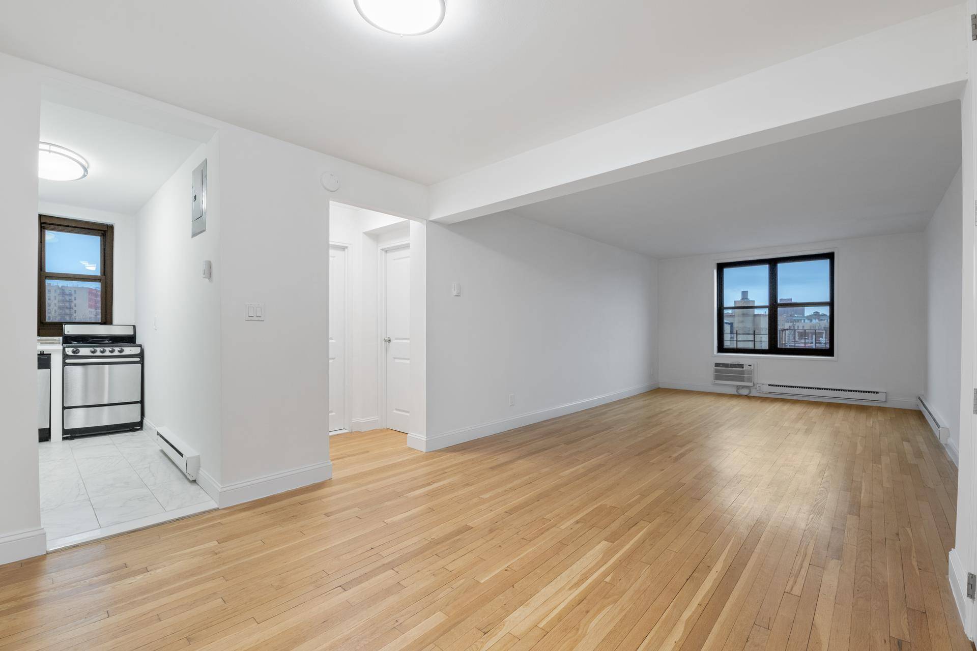 Welcome to this spacious, gut renovated one bedroom, one bath apartment with sunny East and North views, a block from the A train at 181st Street in Inwood Washington Heights.