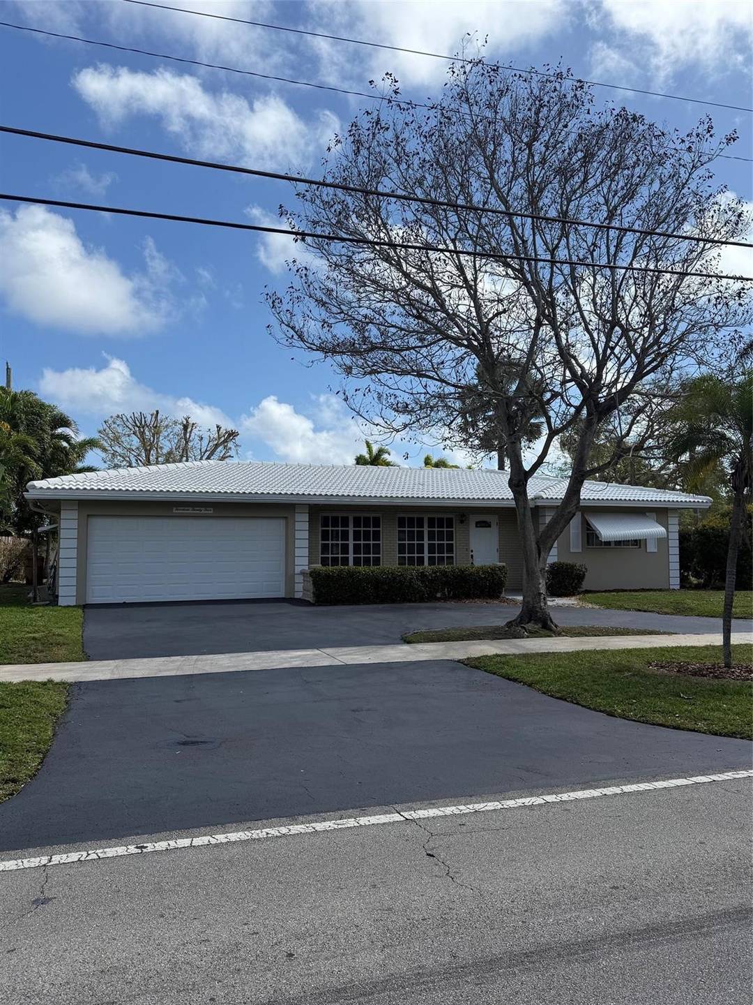 East of Federal Highway, close to beach Just painted Three bedroom two bath with two car garage on corner lot with newer kitchen cabinets and granite countertop and large family ...