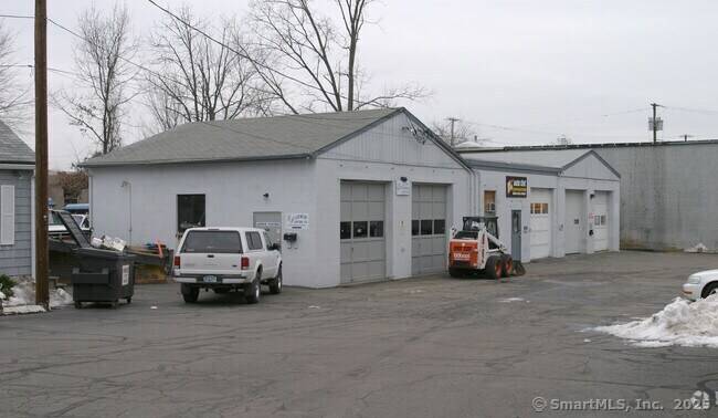 Great Street Presence, Convenient Location Turn this into your Store Front and workshop 2 family house in front with store front separate single family and 5 bay garage and a ...