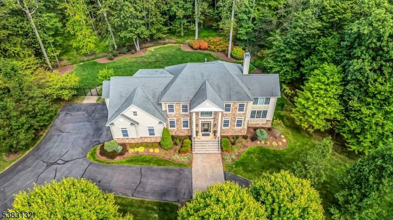Distinguished stonefront Gallagher colonial, tucked away on wooded 3 acre lot offering rare combination of public utilities natural gas !
