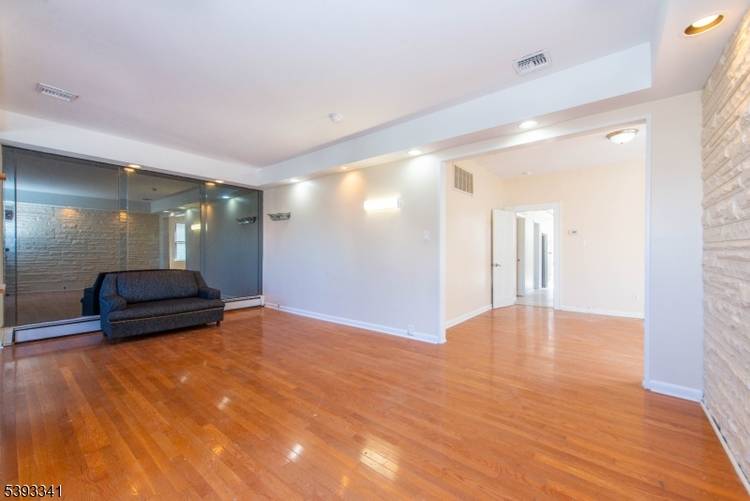 Welcome to 12 Bond Place, a spacious and recently renovated single family home offering five bedrooms and four full bathrooms, including a private primary suite.