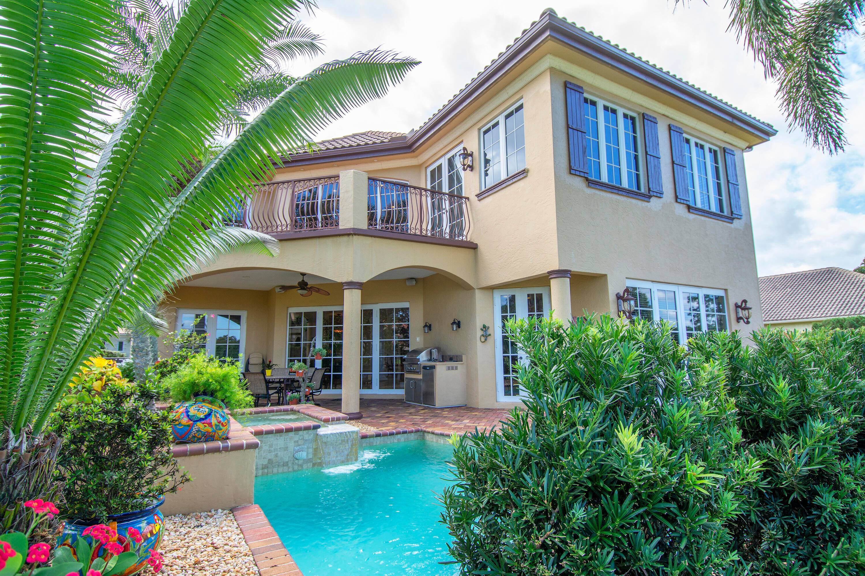 This custom designed home awaits you, featuring an arched entryway lined with columns designed to catch the breezes the eye.