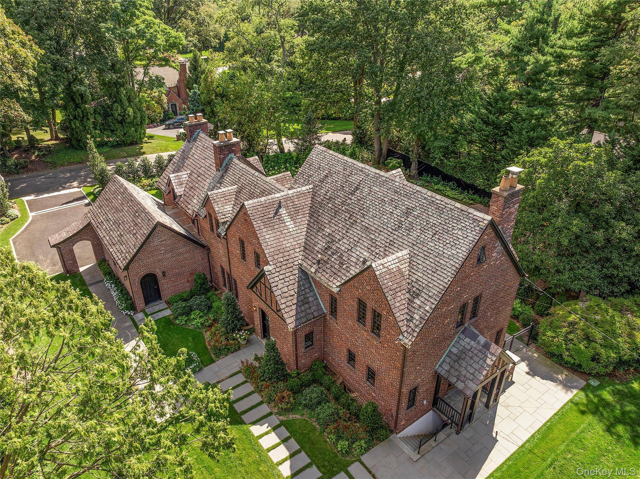 Sited adjacent to, and enjoying the views of the expansive greens of the North Hempstead Country Club golf course, this architecturally significant all brick Tudor sits on a newly landscaped ...