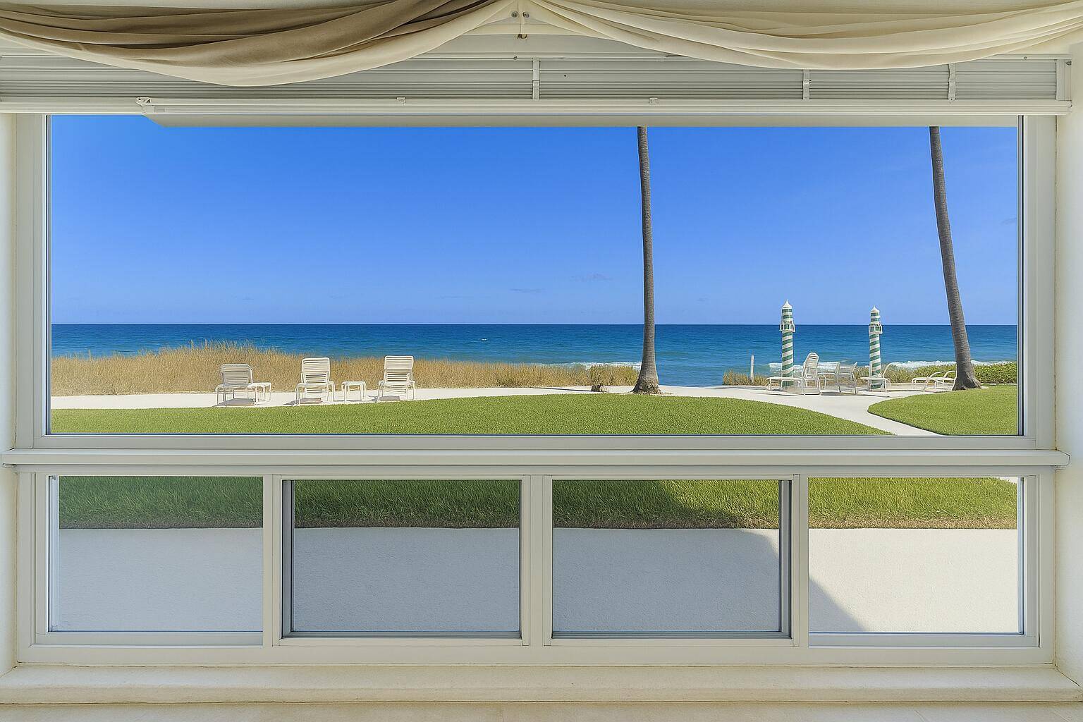 Ocean end corner unit with uninterrupted beach views spanning the full length of the residence.