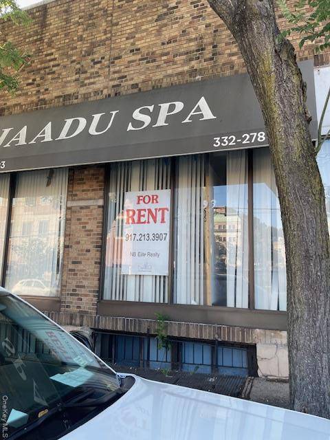 The property is situated in a commercial stretch there are storefronts, shops, and restaurants nearby.