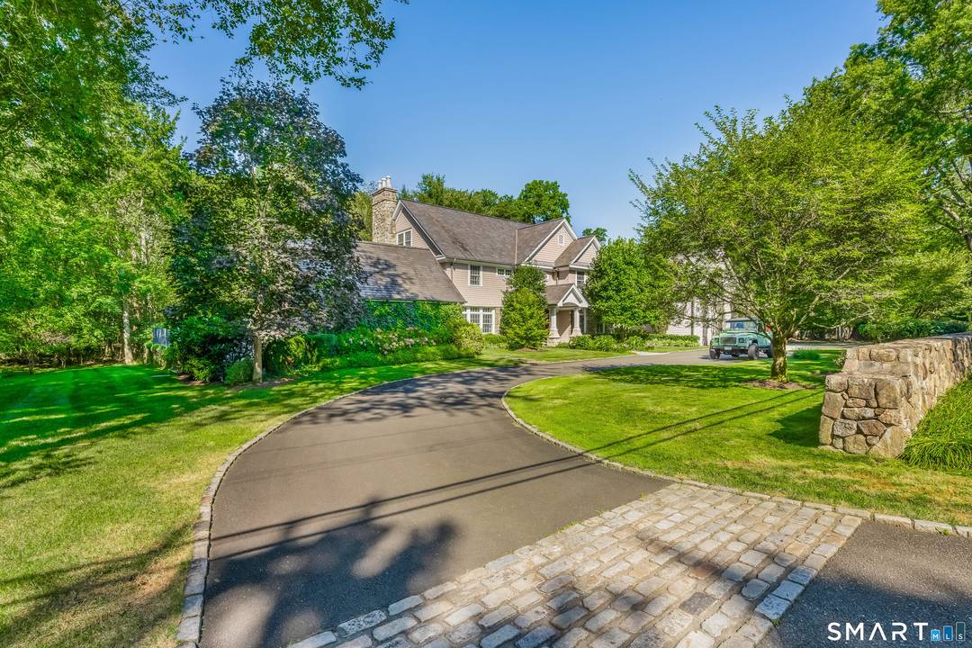Welcome to 473 Hollow Tree Ridge Road in Darien a custom built, stone and shingle Colonial set on 1.