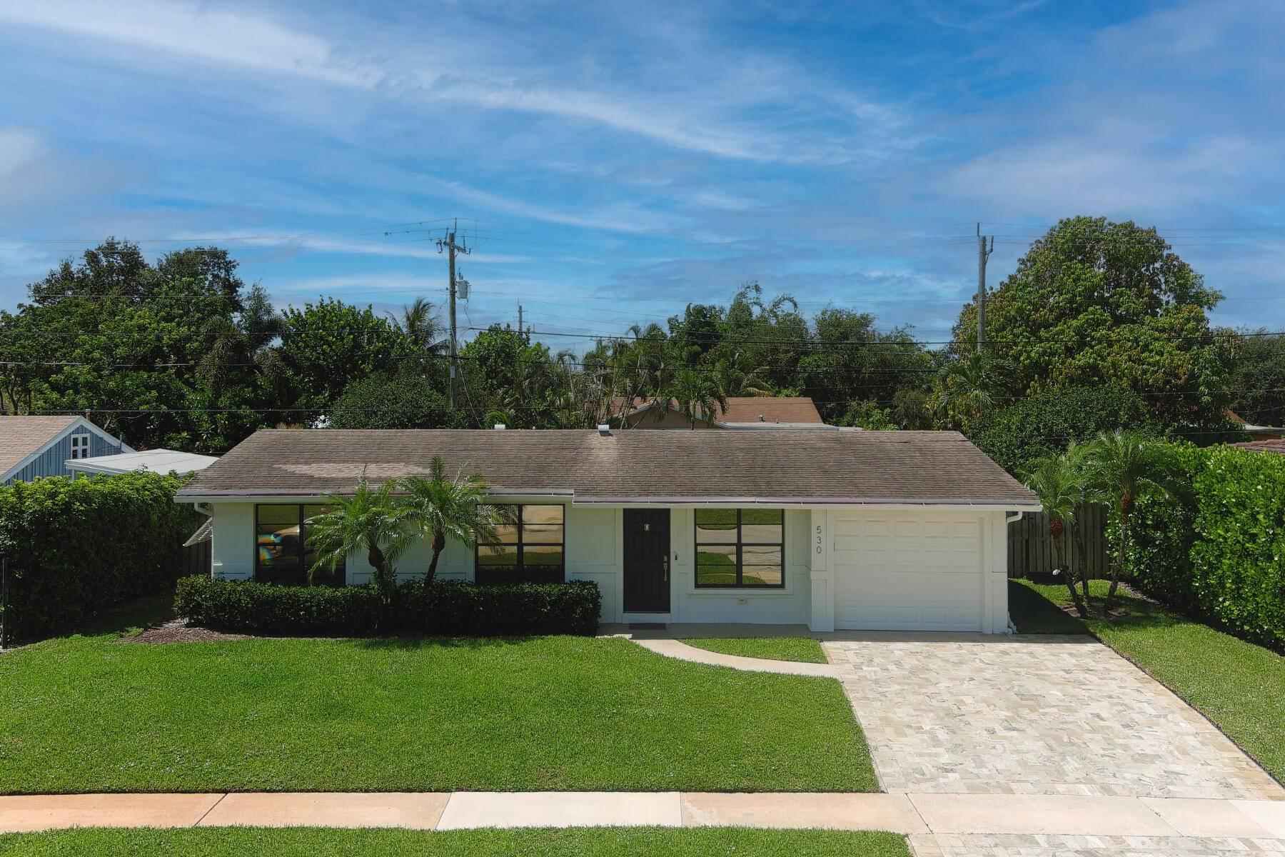 This stunningly remodeled 3br 2ba East Delray heated pool home truly has it all.