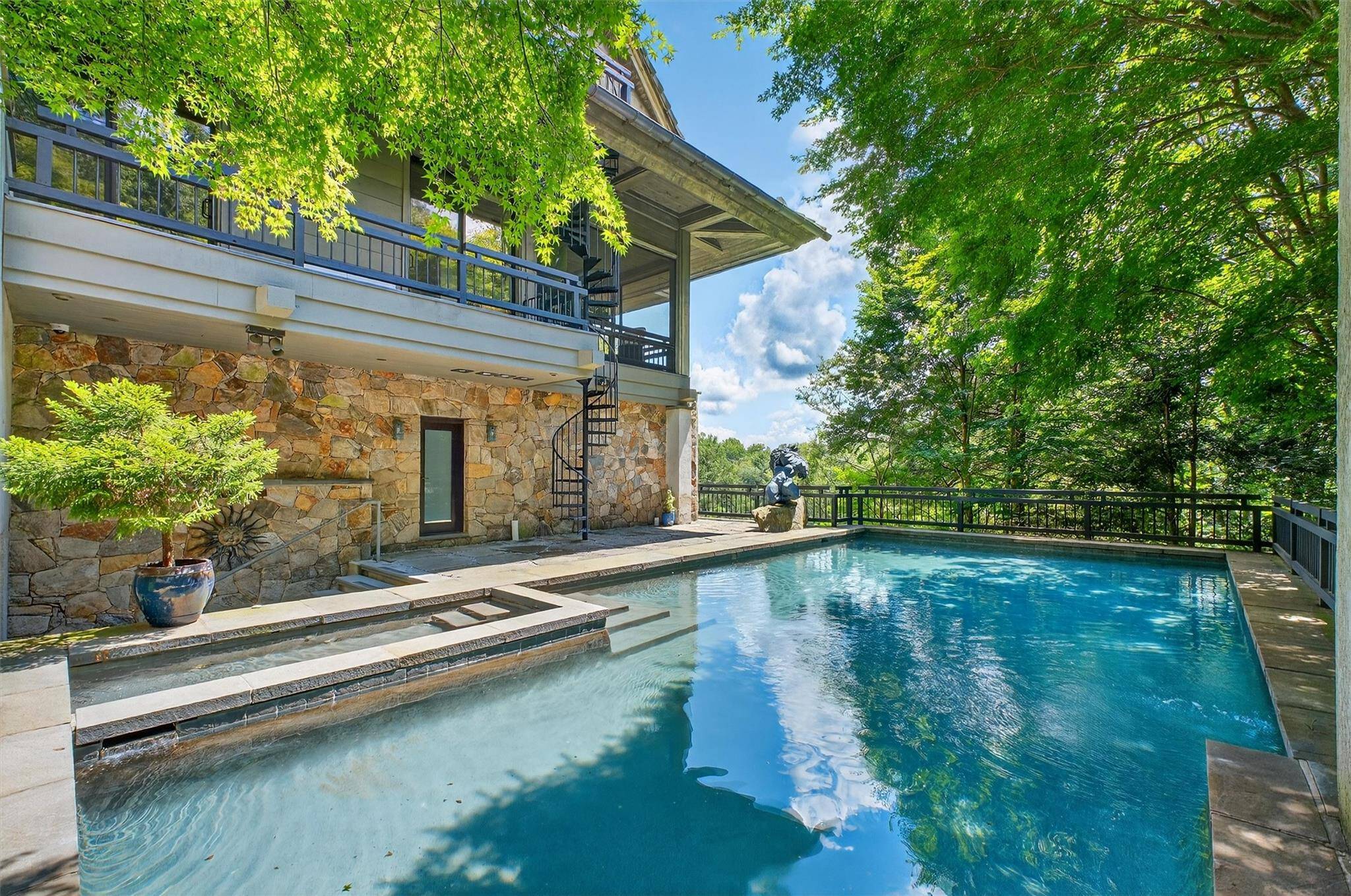Welcome to The Tea House a one of a kind architectural sanctuary perched above Gorge Lake in Pound Ridge, where timeless craftsmanship and natural beauty converge in perfect harmony.