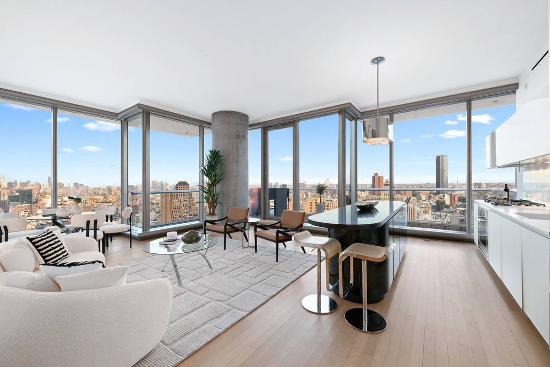 Step into a world of light, space, and luxury in this expansive three bedroom residence, perched high above Tribeca with panoramic skyline and river views.