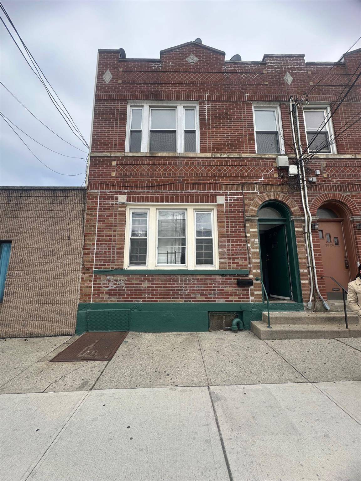 Corona 3 family brick attached house, updated new windows, newer heating system.