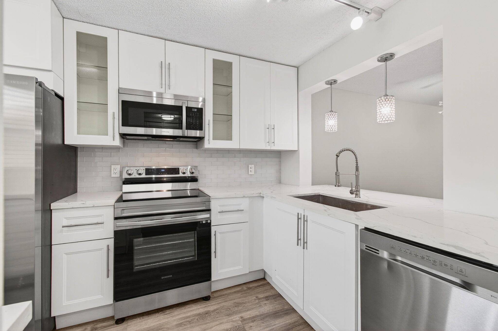 Beautiful 2 bedroom, 2 bath GROUND FLOOR condo with covered parking just steps away from your front door.