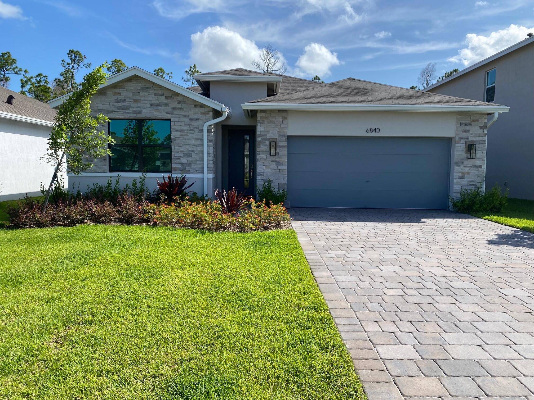 Stunning new 4BR 2BA Delray plan offers stylish single level living with impact glass windows, soft close cabinets, quartz kitchen countertops with waterfall edge, and wood look porcelain tile throughout.