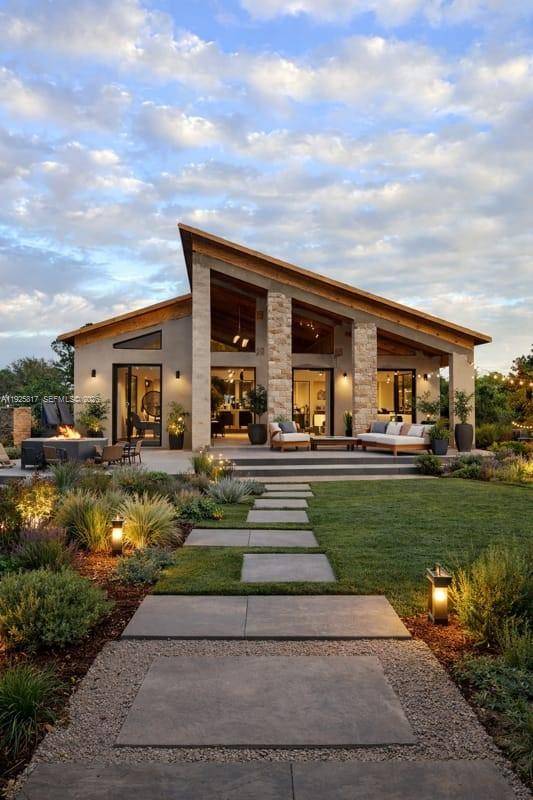 From the moment you arrive, the home impresses with its bold architectural lines, symmetrical fac ade, and dramatic glass elements that invite abundant natural light throughout the interior.