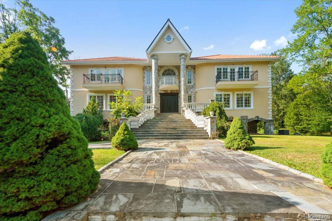 Prime Bedford estate on over 9 acres of open, level land with a small bridge crossing your private pond to enter.