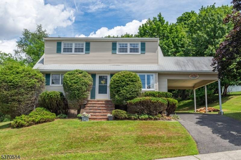 Nestled in a desirable mountainside neighborhood, this Expanded Cape Cod home offers scenic elevation and spacious living.