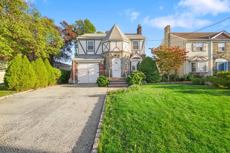 Welcome to this enchanting Storybook Tudor nestled on a beautiful, tree lined street.