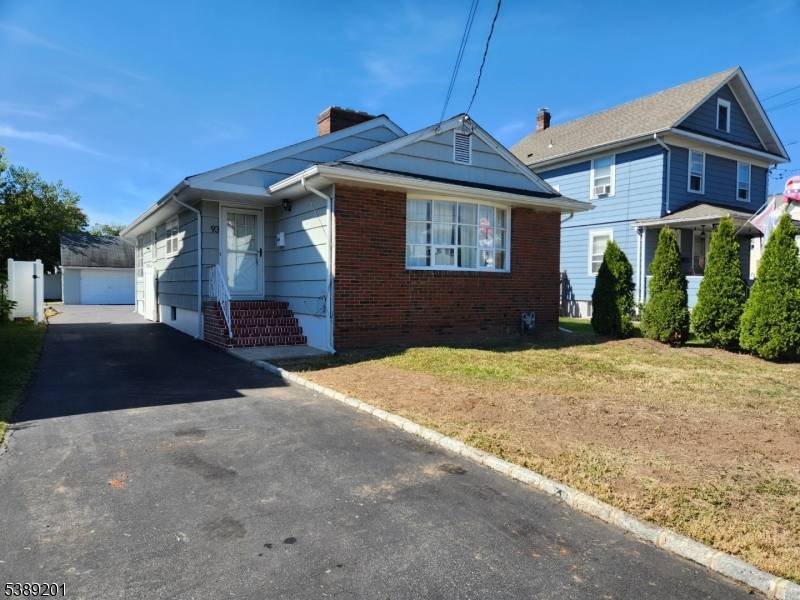 Wonderful Ranch with parking lot and huge concrete block garage.
