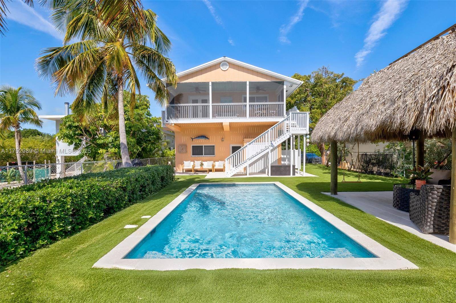 Assumable VA Loan. Enjoy gentle breezes from your back porch, overlooking serene nature, sparkling new pool and tiki hut.