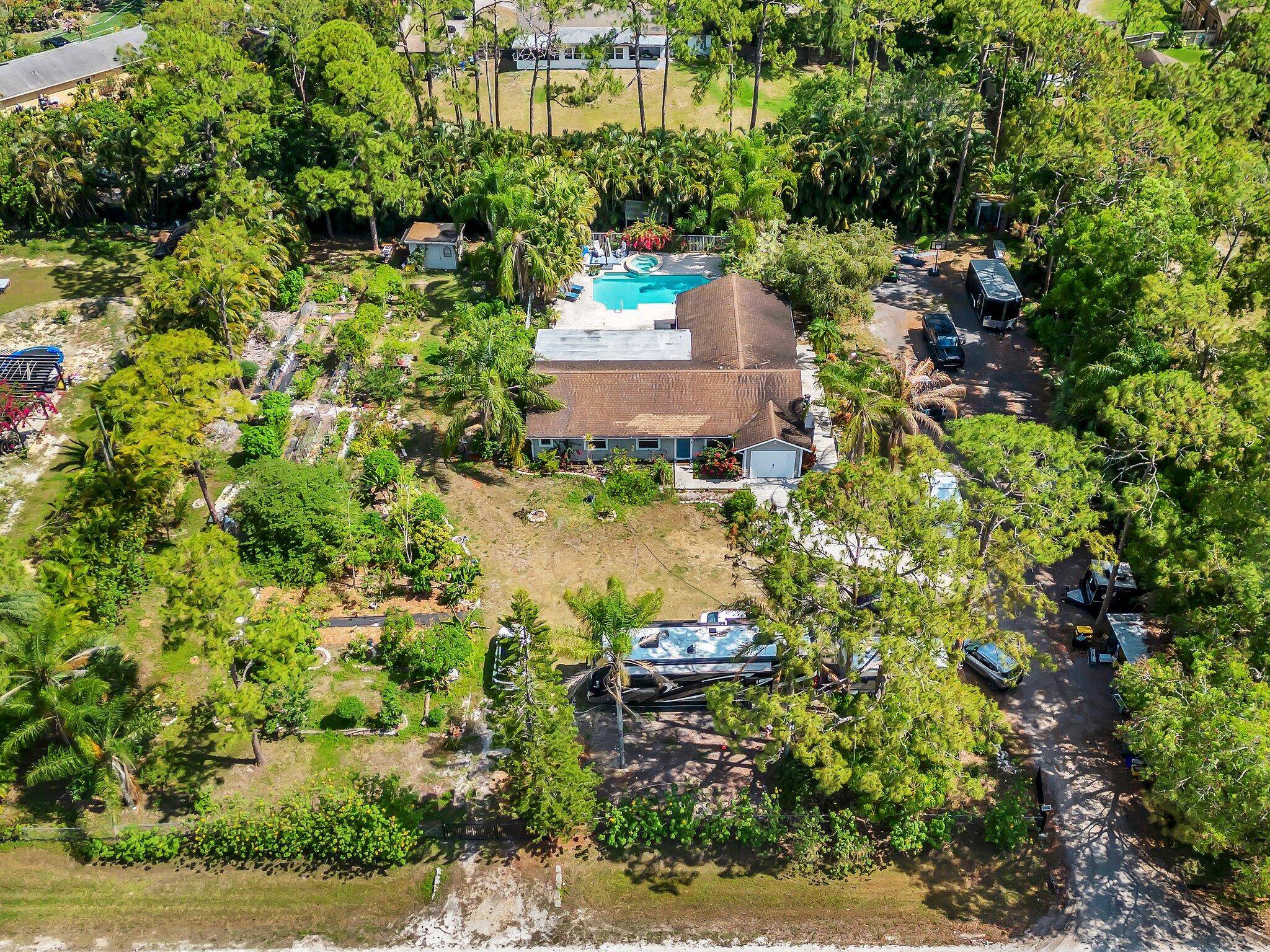 Updated 1. 14 acre, 3 BR 2 BA pool home with a mature fruit vegetable garden and plenty of outdoor storage.