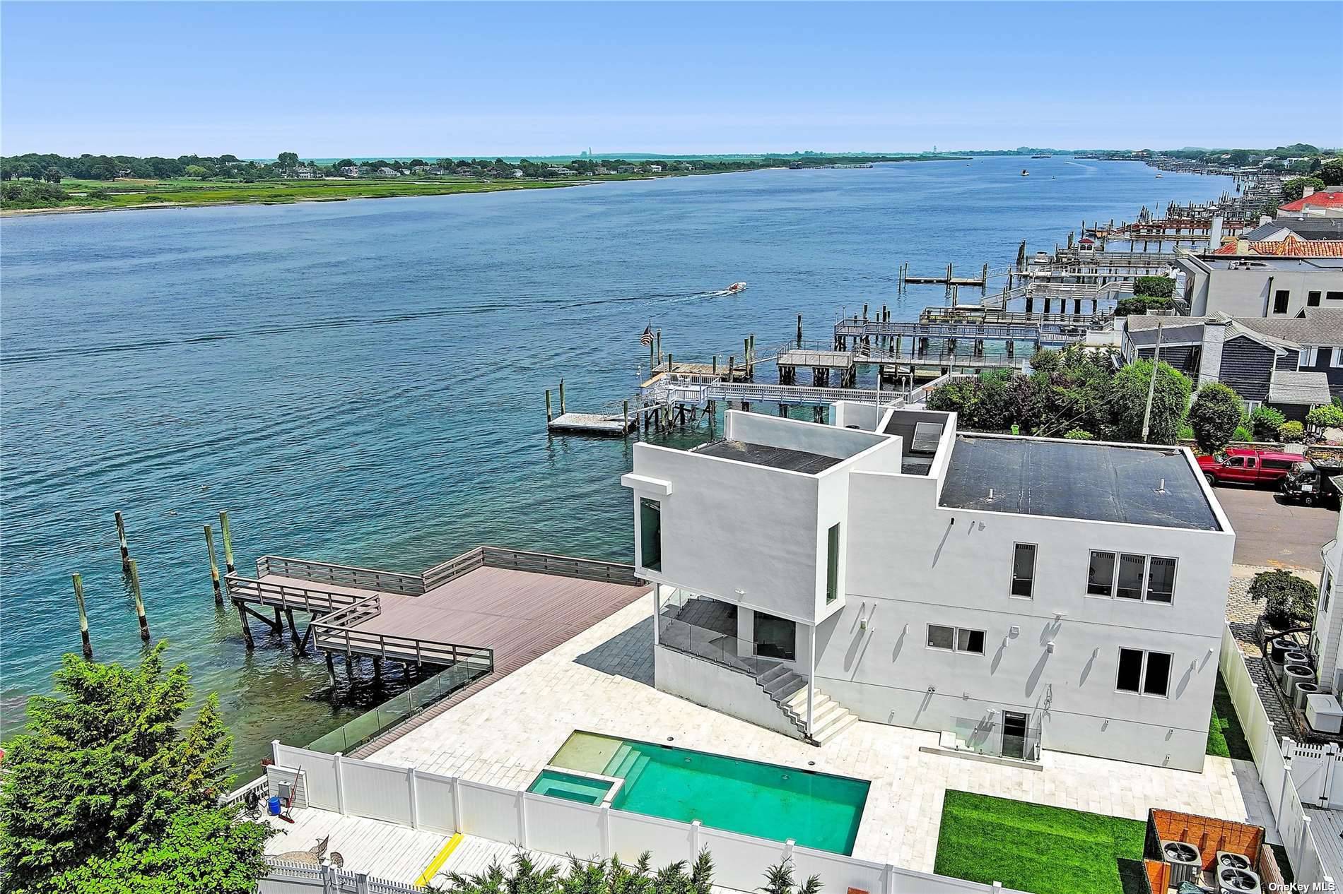 Live the dream in this exquisite, brand new private residence majestically overlooking the pristine waters of Reynolds Channel and the Rockaway Inlet in desirable Atlantic Beach.