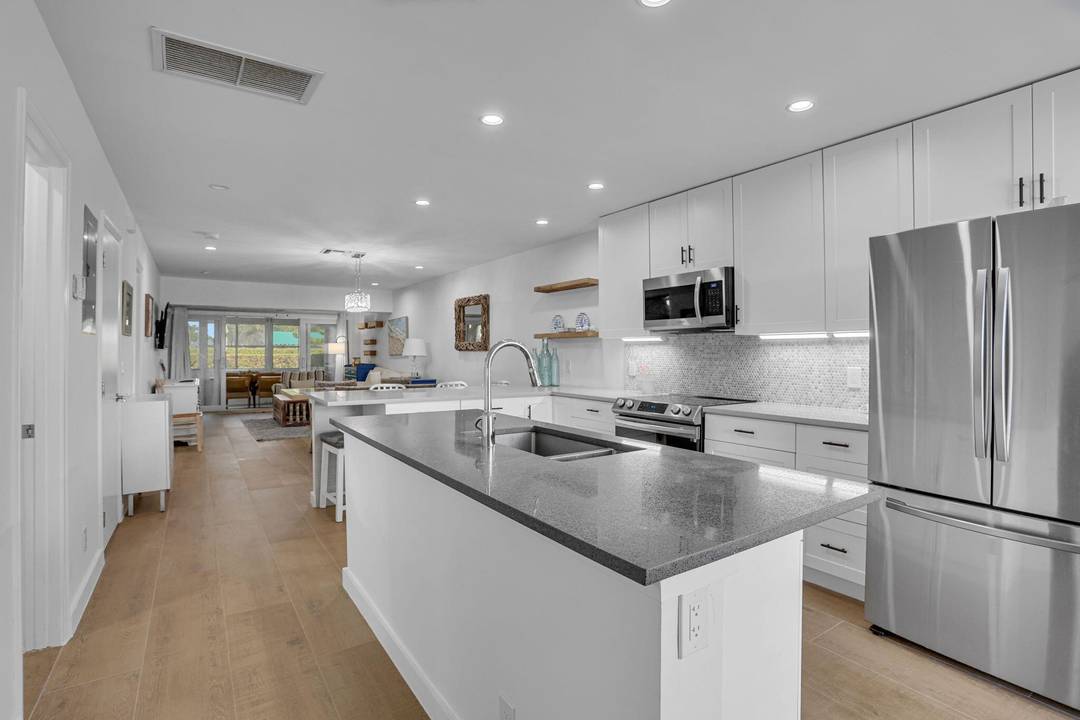 PINES OF DELRAY EAST Totally renovated one story villa 2 bed 2 bath with southern garden view and a private back patio with seating and a gas grill.