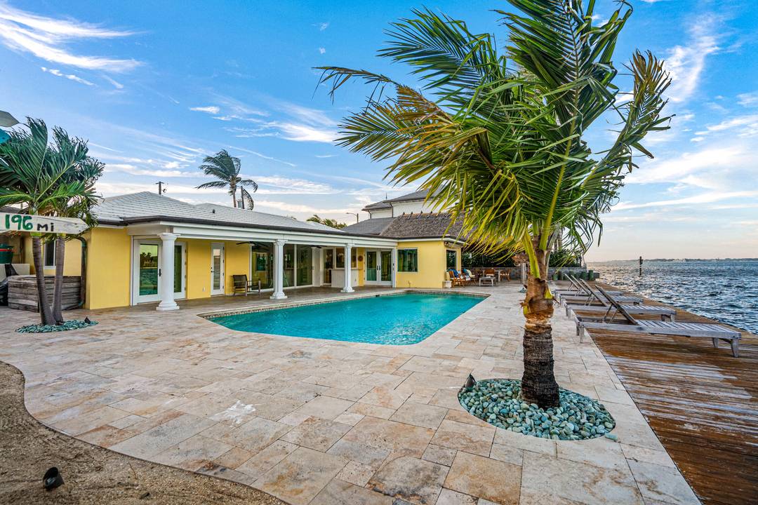 Escape to this beautifully updated tropical waterfront home, where serene water views and vibrant natural light surround you from every room.