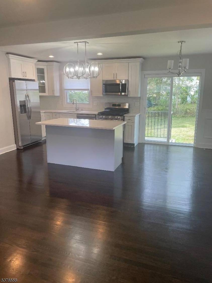 Completely renovated 4 bed, 3 full bath home, Kitchen island, fireplace, sliding glass doors to private yard.