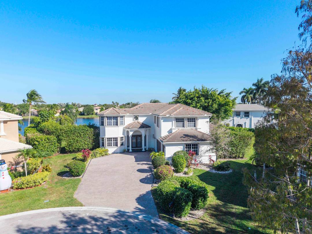 Resort lifestyle ! This colossal 7 BR waterfront estate is the largest in the community, set on a rare.