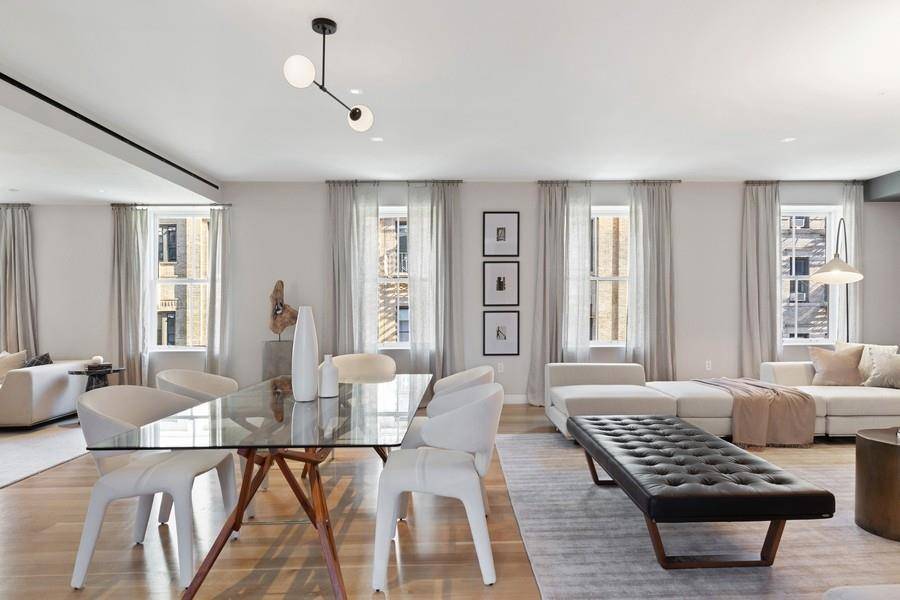 A four bedroom, four bath duplex plus powder room with working fireplace, expansive, open plan living dining great room, a large garden terrace visible from the kitchen living area, a ...