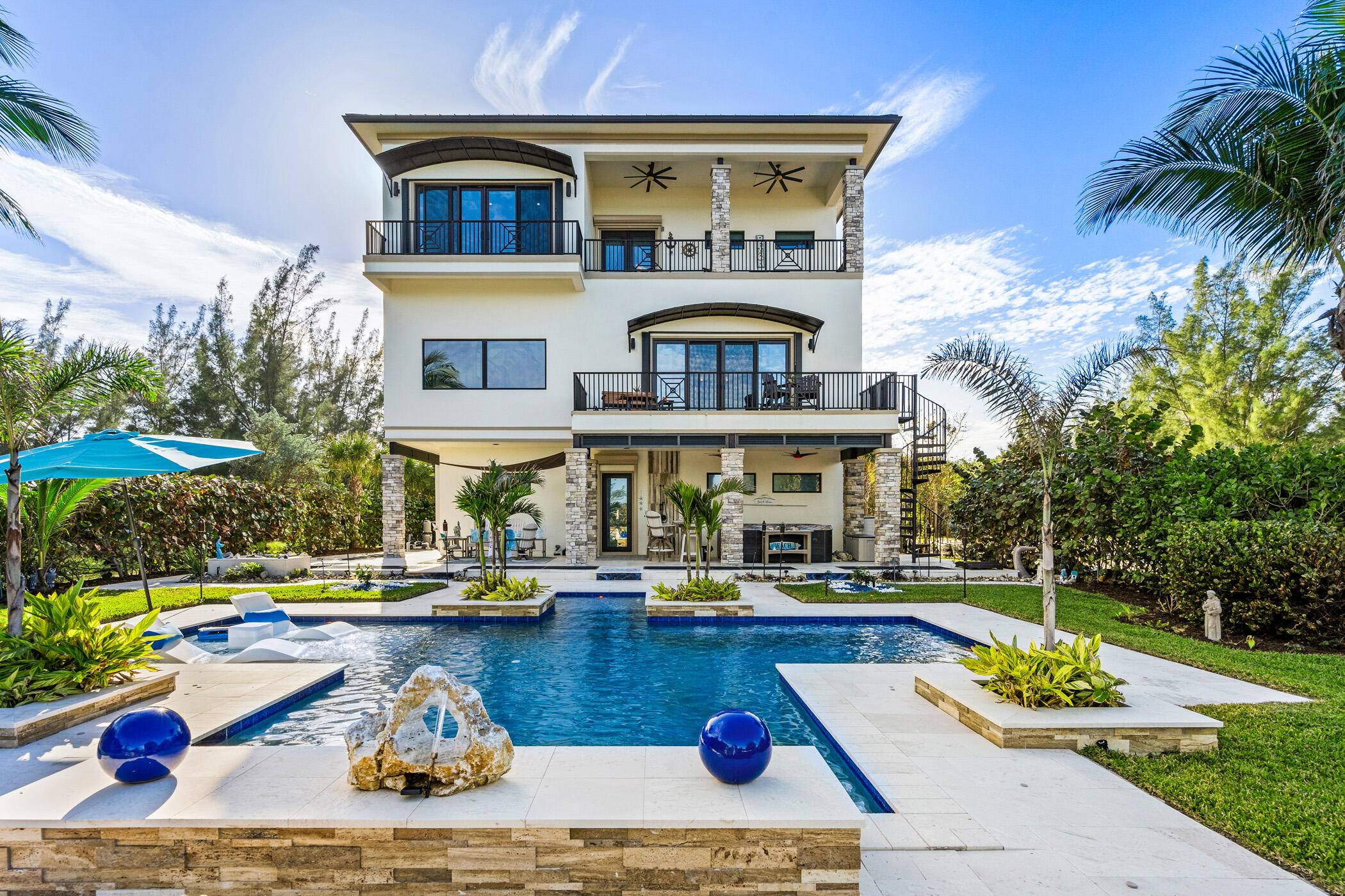 Modern oceanfront estate perfectly infuses luxury coastal living in exclusive 10 home enclave set far back from A1a for complete privacy.