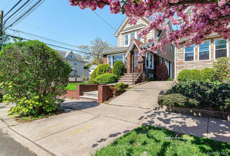 Stately colonial perched on a corner 25 x 100 lot.