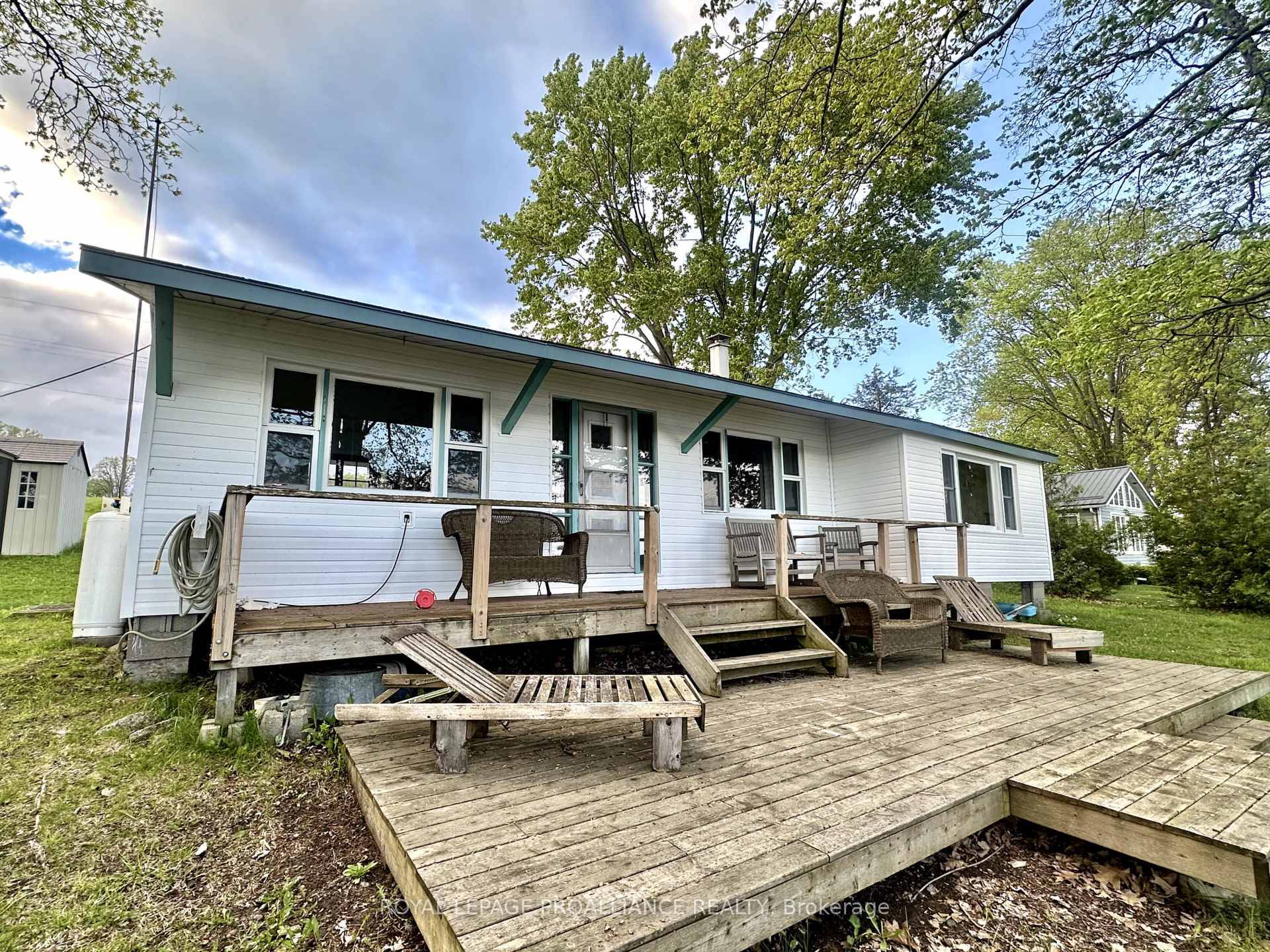 Welcome to 32 Quinte View Rd your charming lakeside escape with fresh updates and timeless cottage vibes.