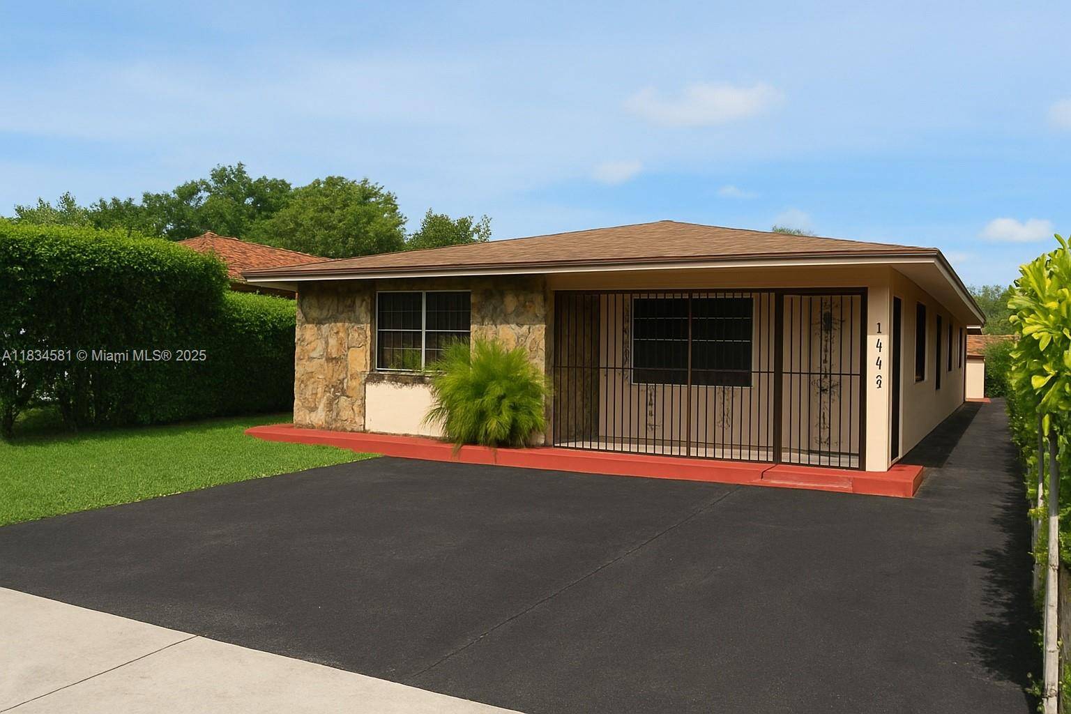 Spacious West Miami home with in law quarters and additional concrete block storage building.