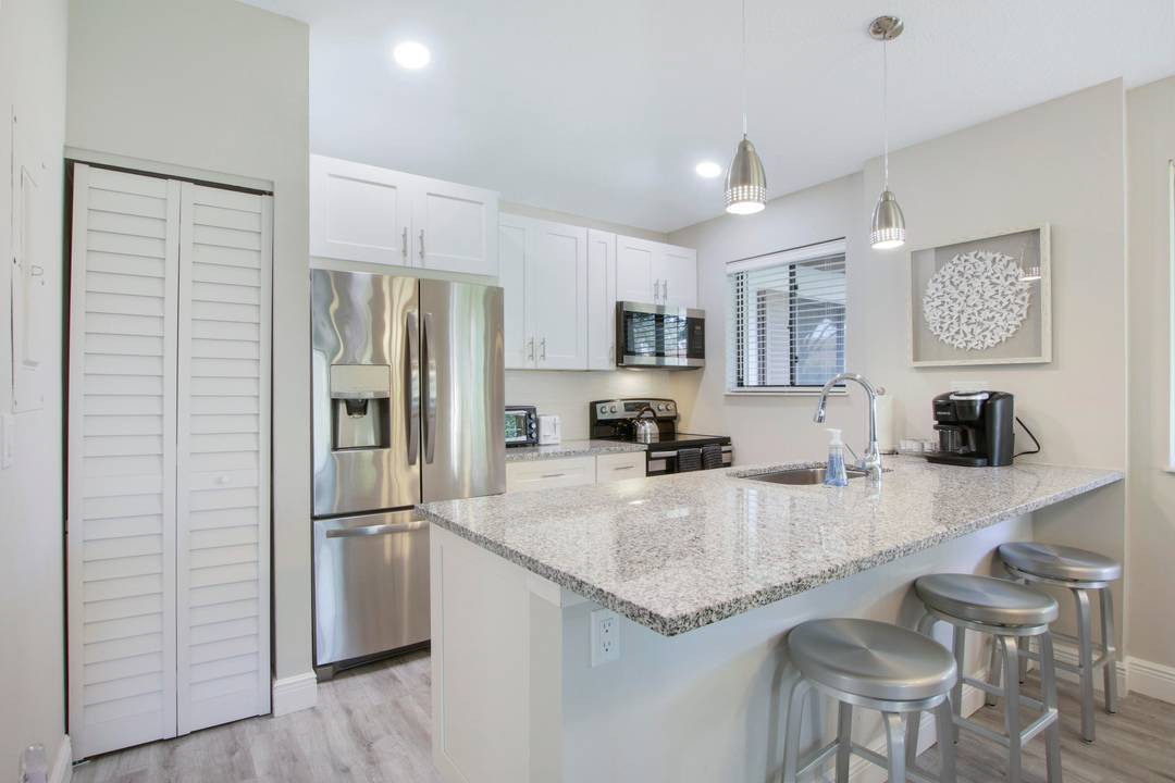 Escape to this immaculate cottage nestled in the heart of PGA National.