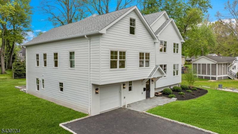 Experience luxury living in the heart of New Providence with this stunning new construction home by NWS Construction and Dana Marceline Design.