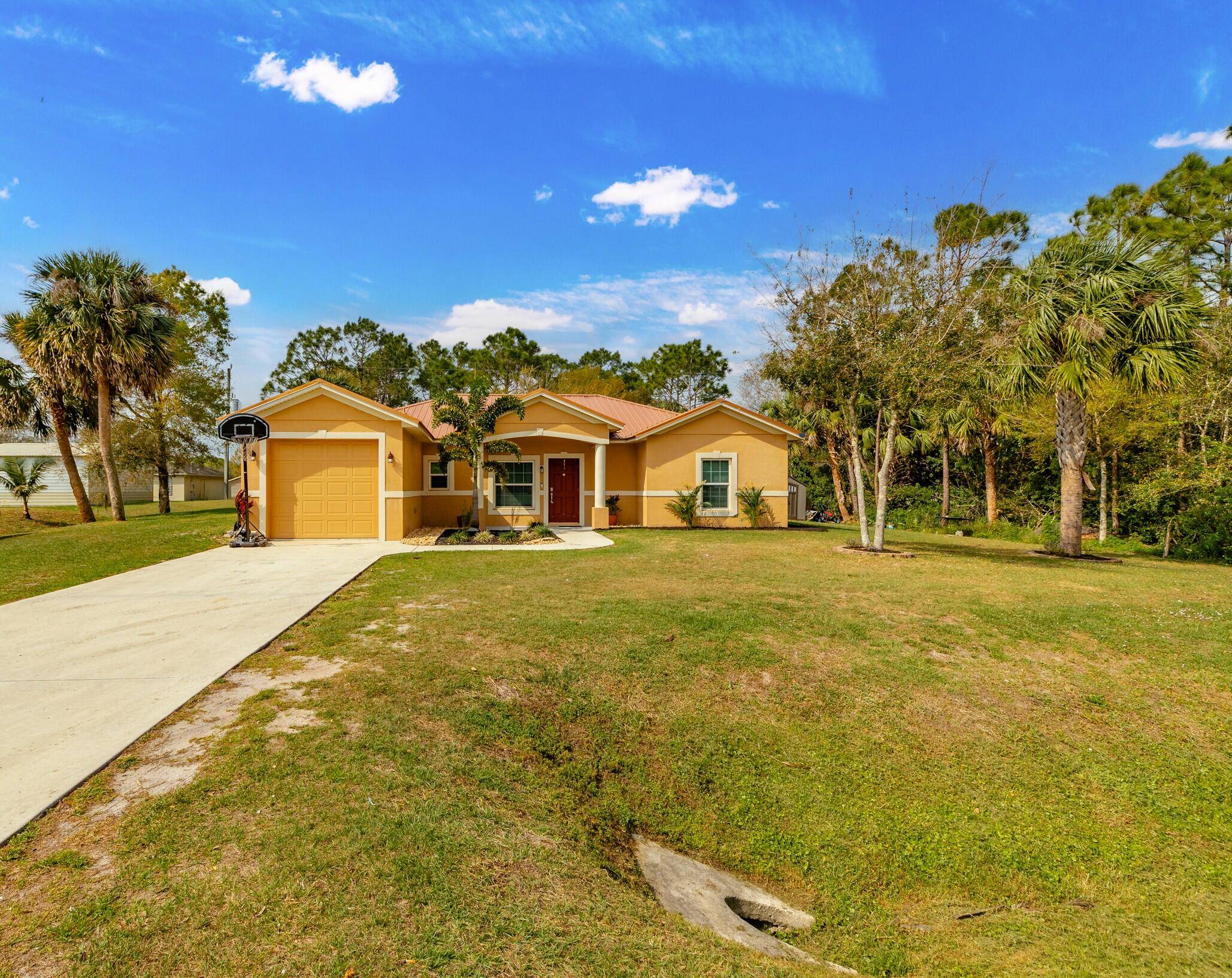 Charming 3 bedroom, 2 bath concrete block home offers a metal roof and impact windows.
