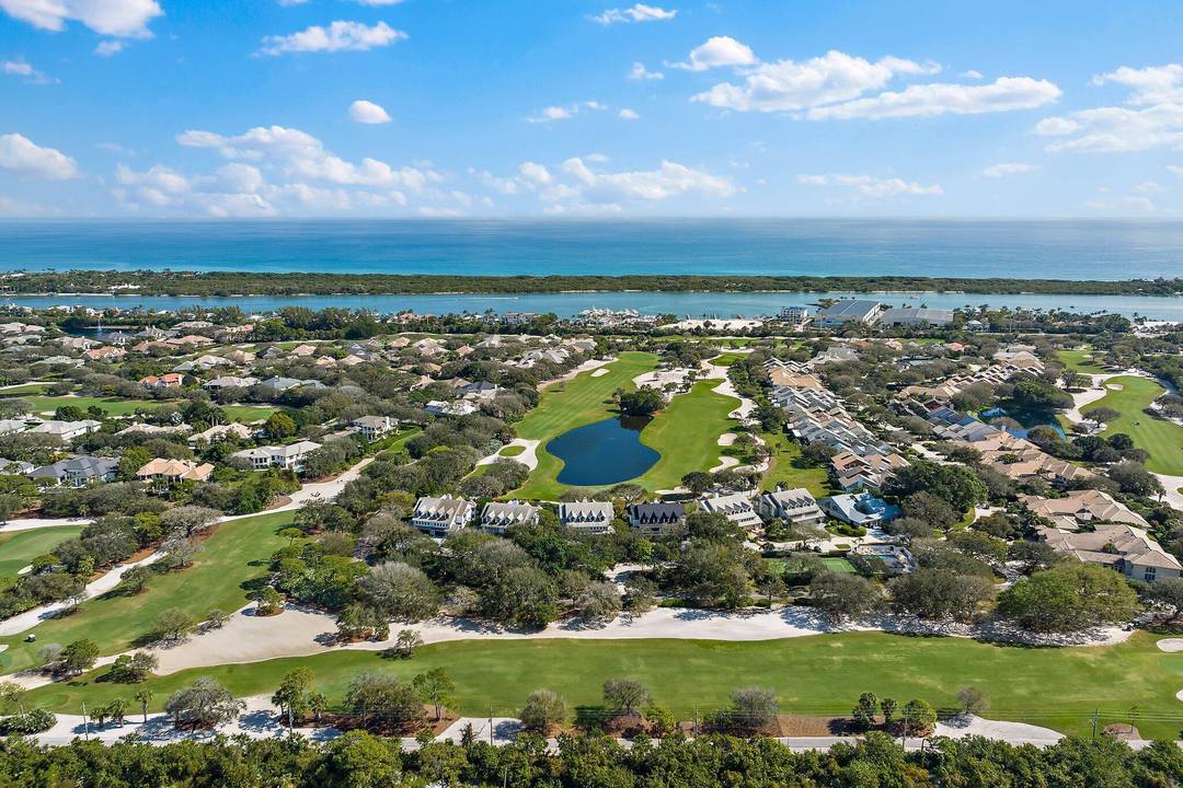 Amazing golf and water views from this totally renovated and sophisticated townhome in Jupiter Hills Village.