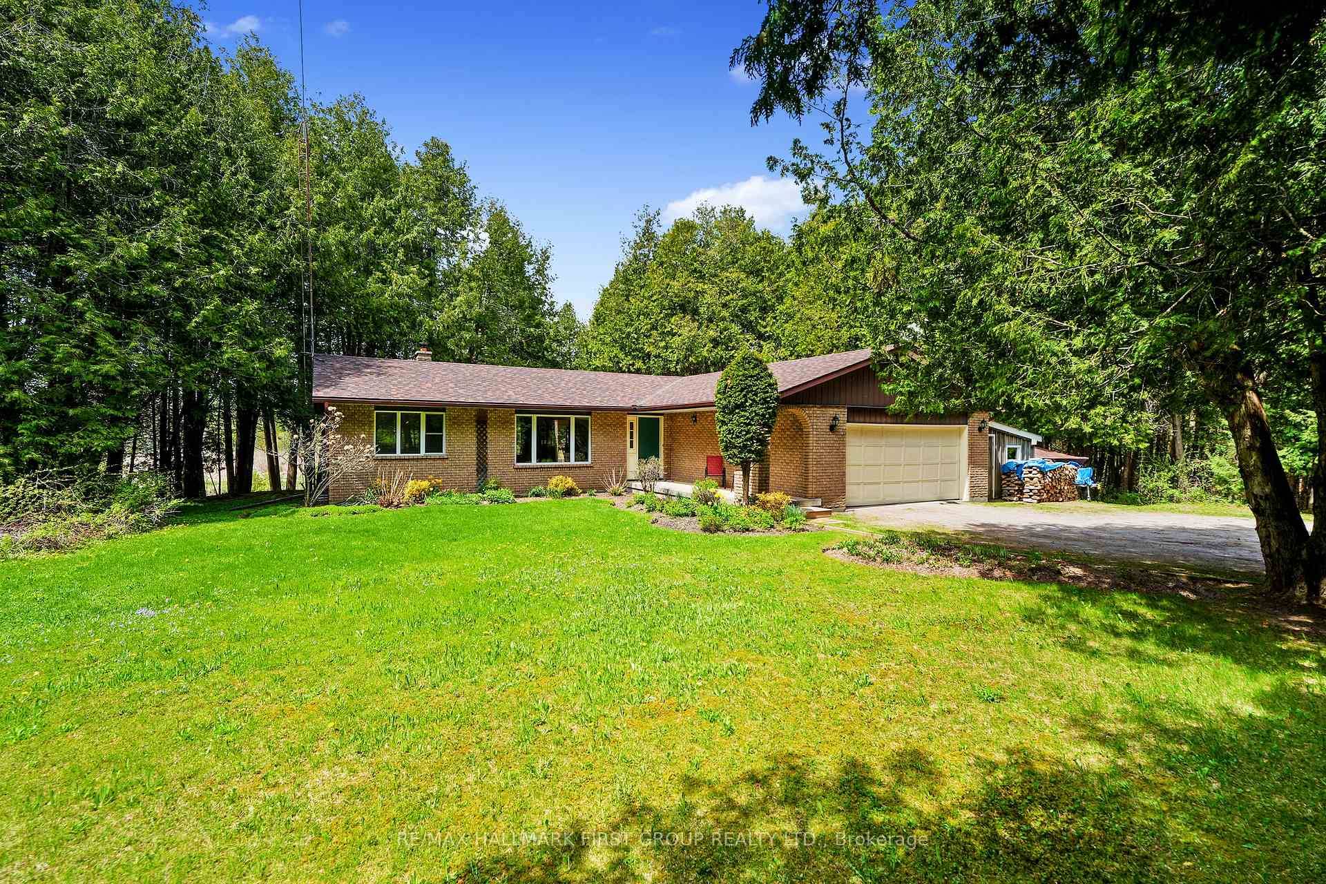 Classic charm meets country living in this timeless brick bungalow on 25 forested acres.