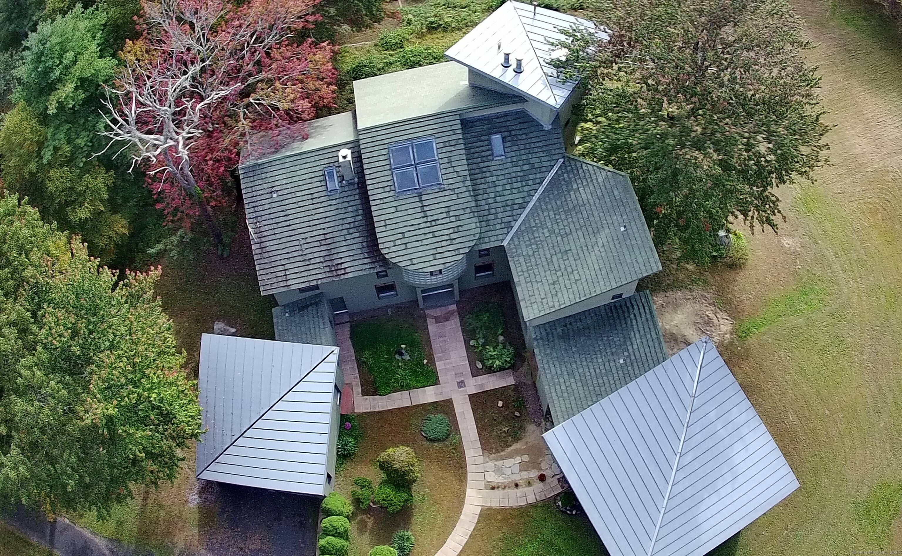 Thoughtfully designed for the 21st century, and mindful of quality and sustainability in every detail, this unique home sits high above Ridge Road with privacy and timeless views.