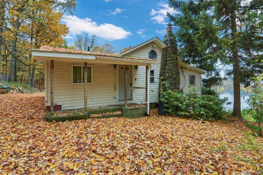 Mini Charmer ! Over a 1 3 acre property perched on top of a hill surrounded by trees.