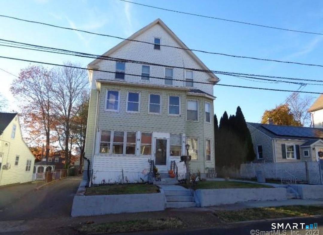 Great investment opportunity with this large 3 family home with off street parking, fenced in yard, and a 2 car garage.