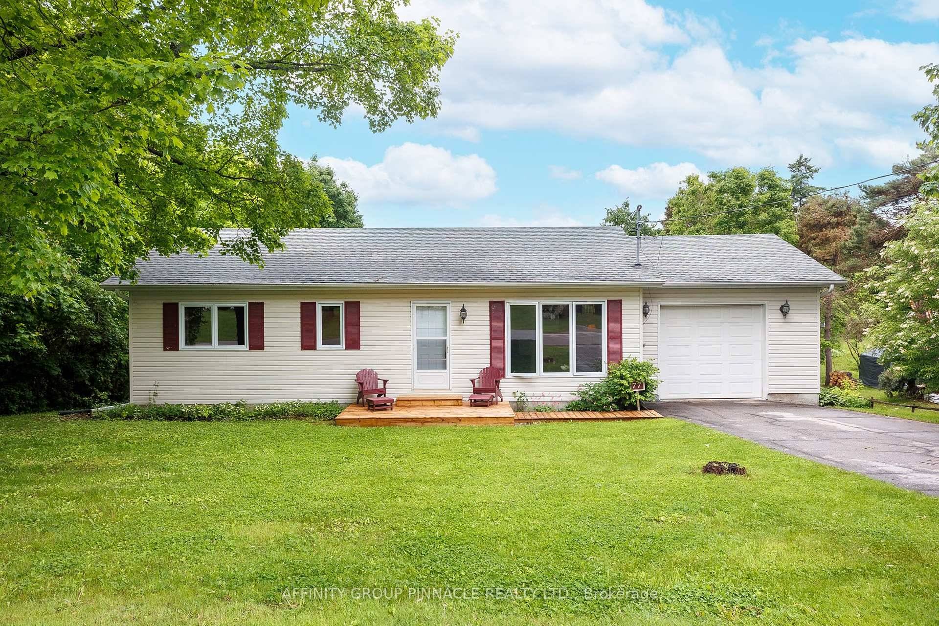 In town bungalow with a walkout basement to a park like half acre property in Fenelon Falls.