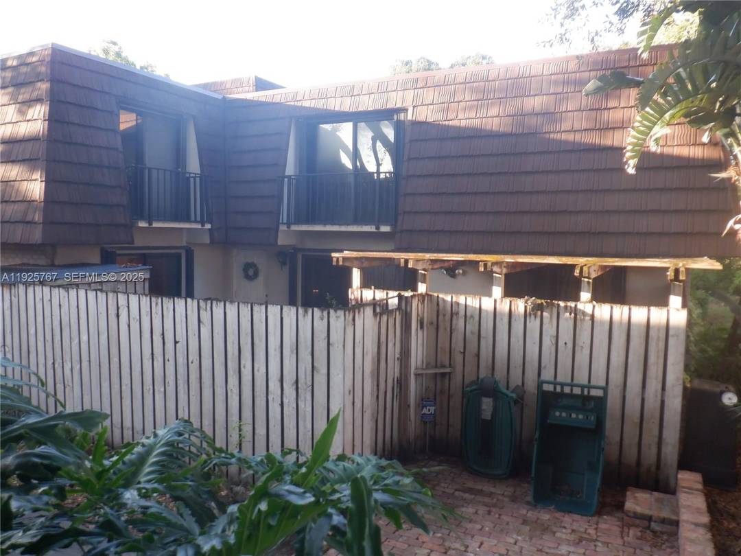 Oak tree shaded outside area with unique brick paved entry.